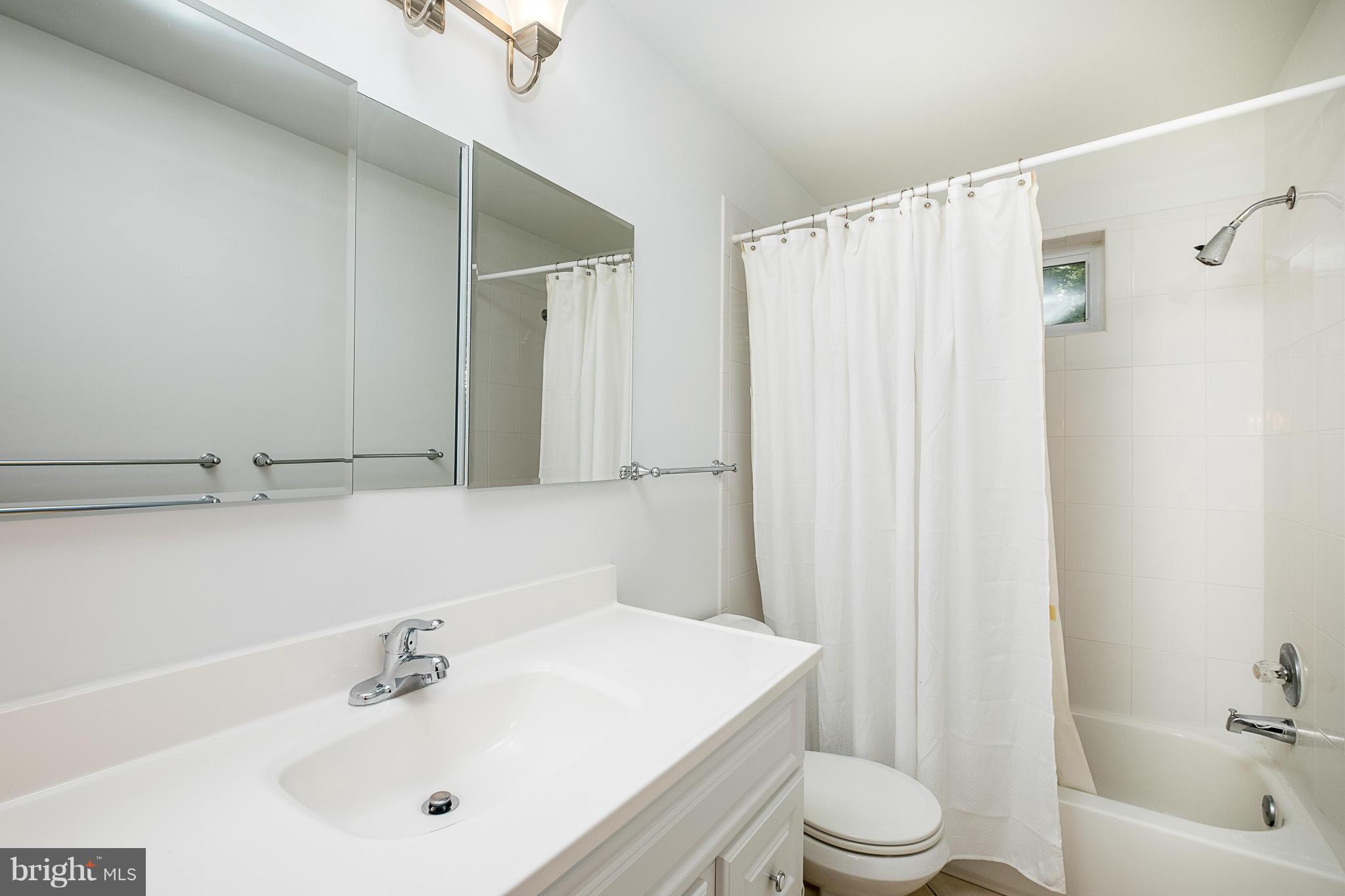 1412 Winding Waye Lane Silver Spring, MD 20902 - Photo 20 of 30 a bathroom with a sink toilet and shower