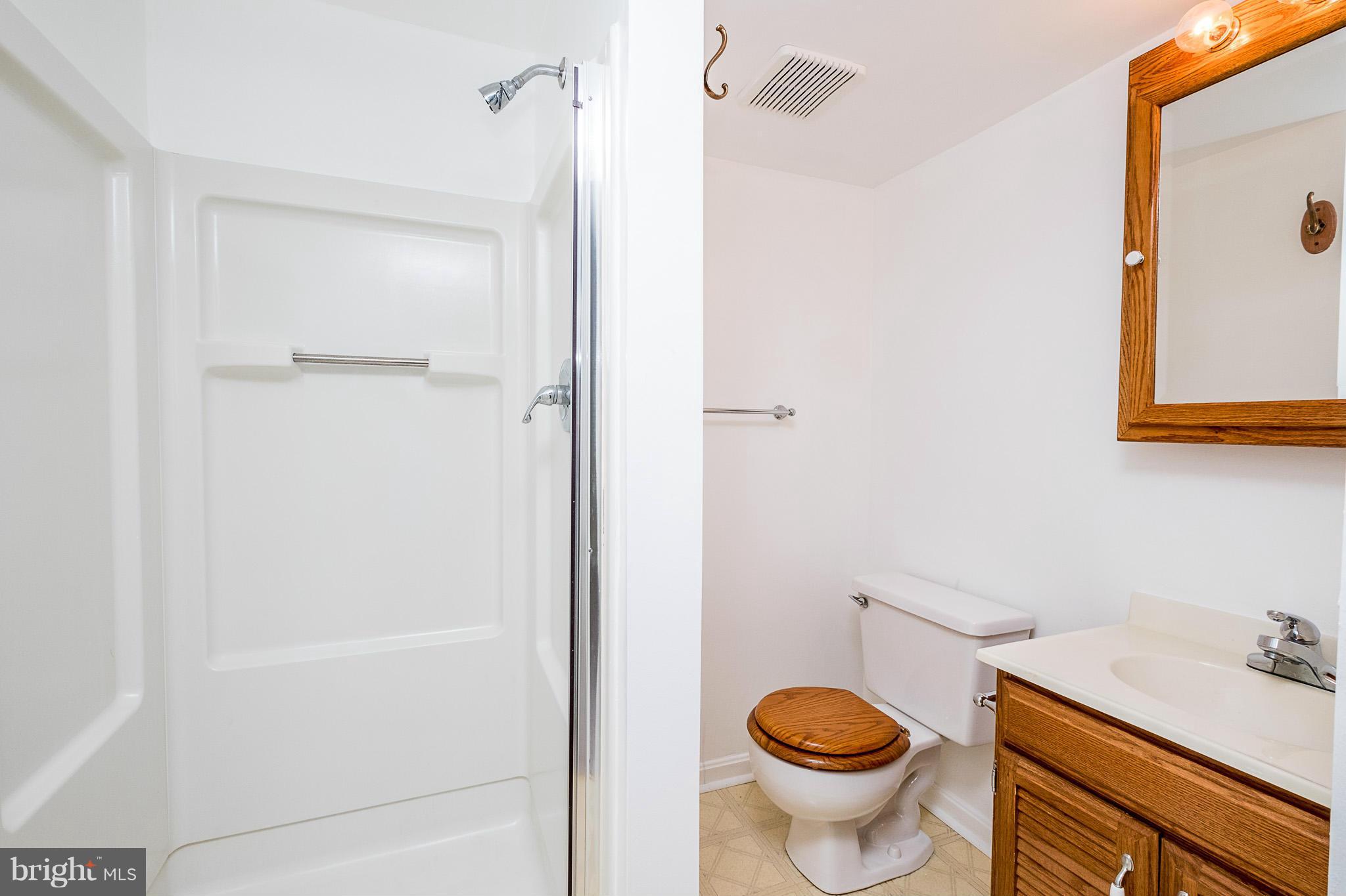 1412 Winding Waye Lane Silver Spring, MD 20902 - Photo 22 of 30 a bathroom with a granite countertop toilet and a sink