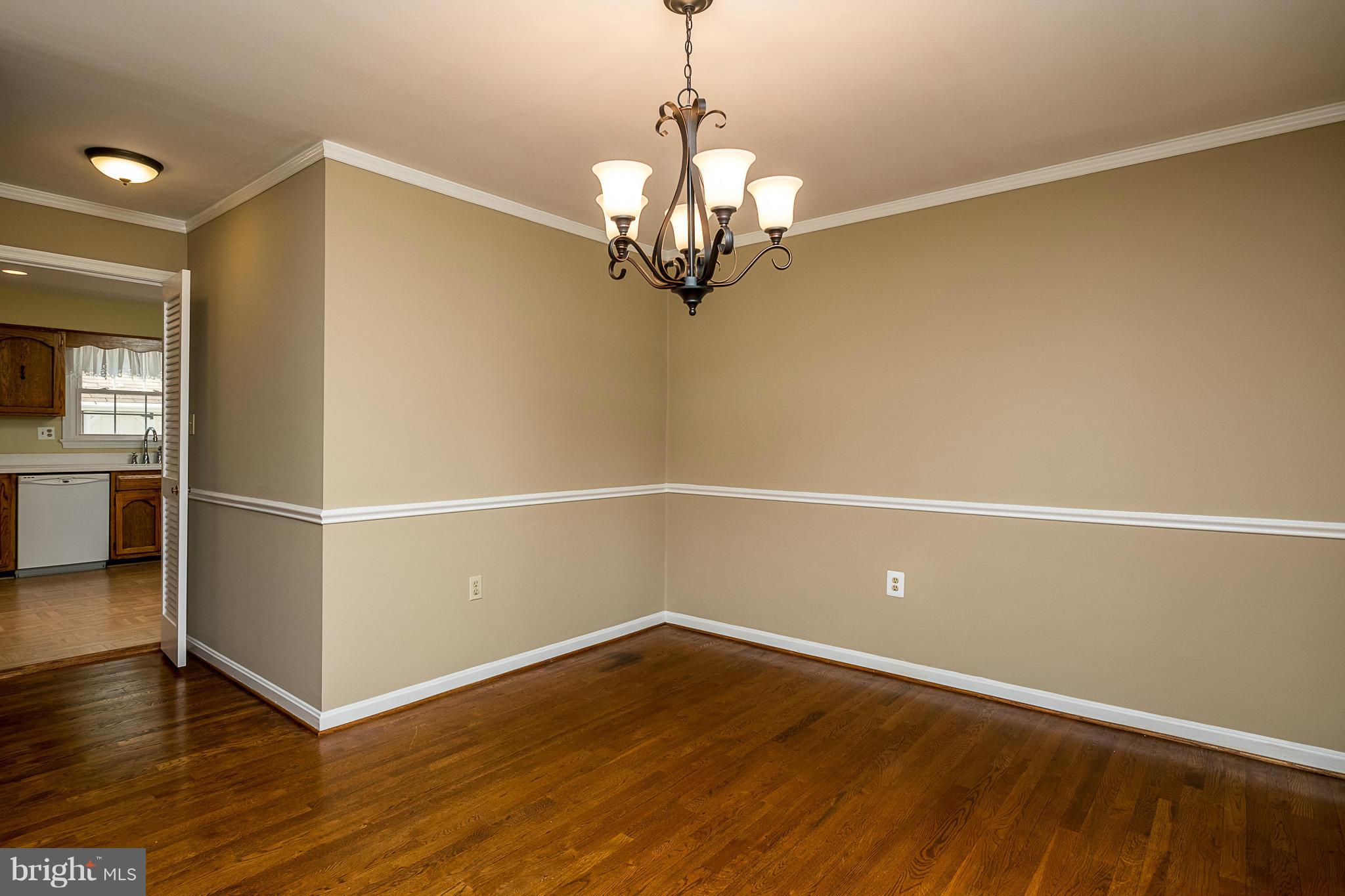 1412 Winding Waye Lane Silver Spring, MD 20902 - Photo 5 of 30 a view of a room with wooden floor staircase and a ceiling fan