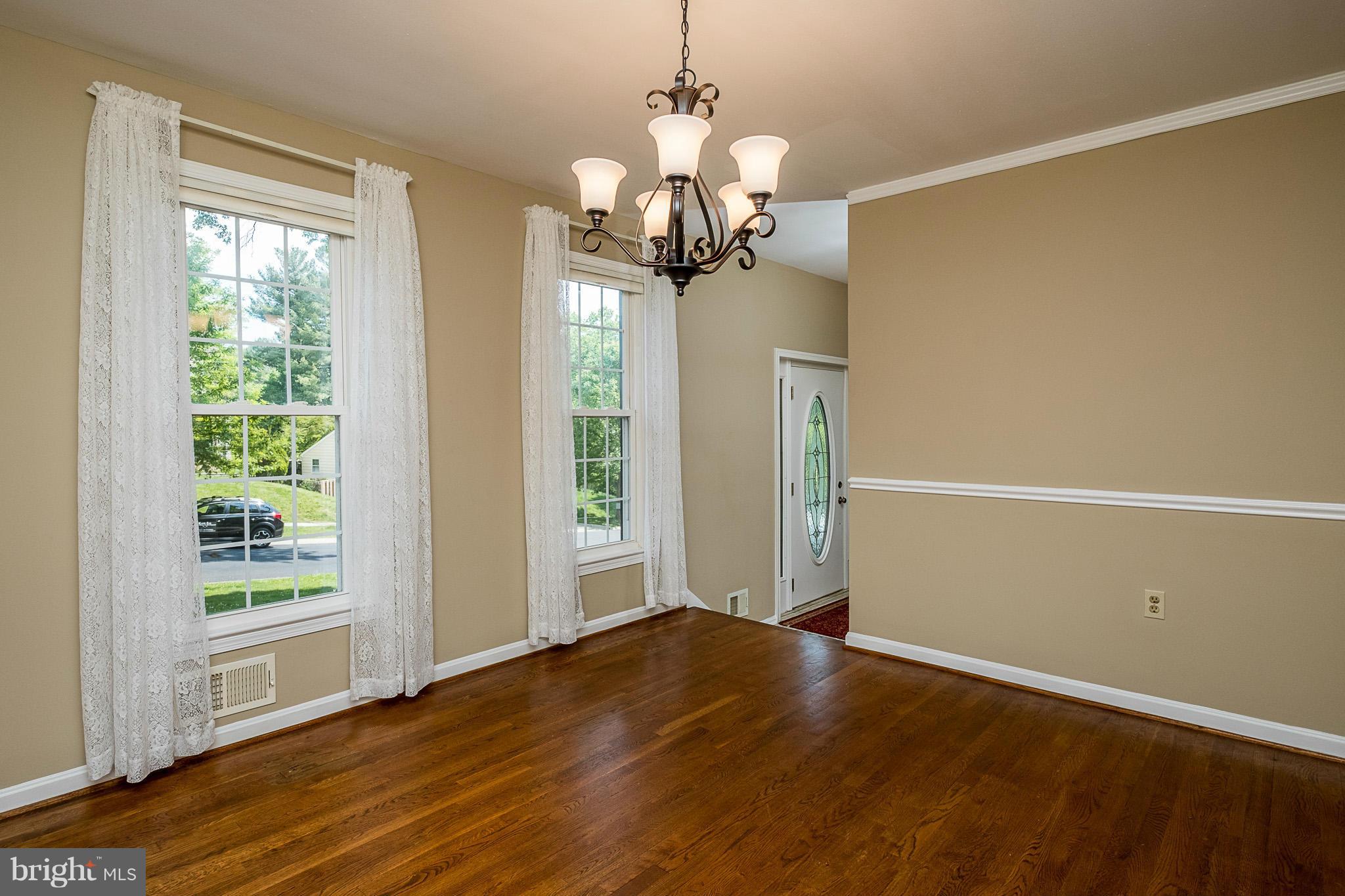 1412 Winding Waye Lane Silver Spring, MD 20902 - Photo 6 of 30 a view of a room with wooden floor and chandelier