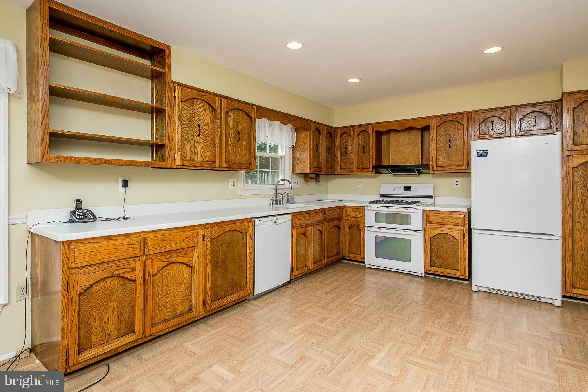 1412 Winding Waye Lane Silver Spring, MD 20902 - Photo 8 of 30 a kitchen with stainless steel appliances granite countertop a stove a sink dishwasher and a refrigerator
