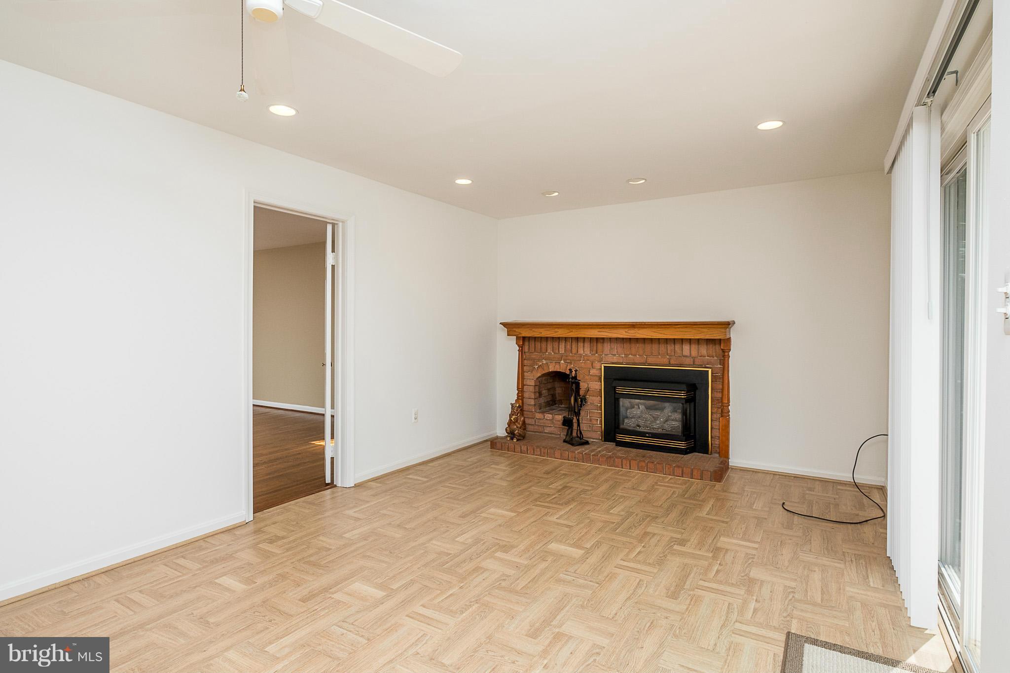 1412 Winding Waye Lane Silver Spring, MD 20902 - Photo 10 of 30 a view of an empty room with a fireplace and a window