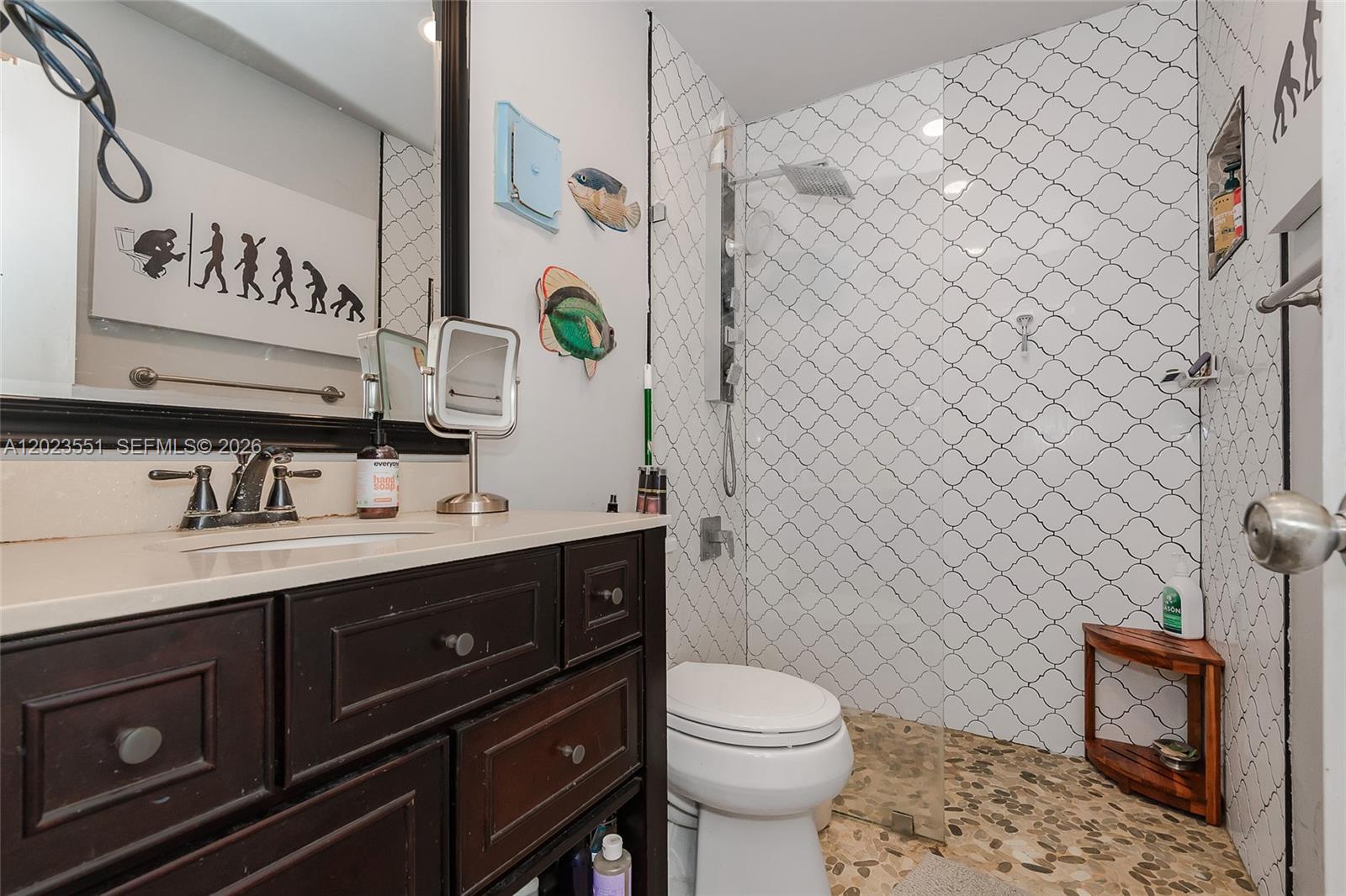 11482 Southwest 109th Road, Unit 29A Miami, FL 33176 - Photo 18 of 28 a bathroom with a toilet sink and mirror