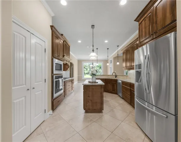 a kitchen with a refrigerator and a sink