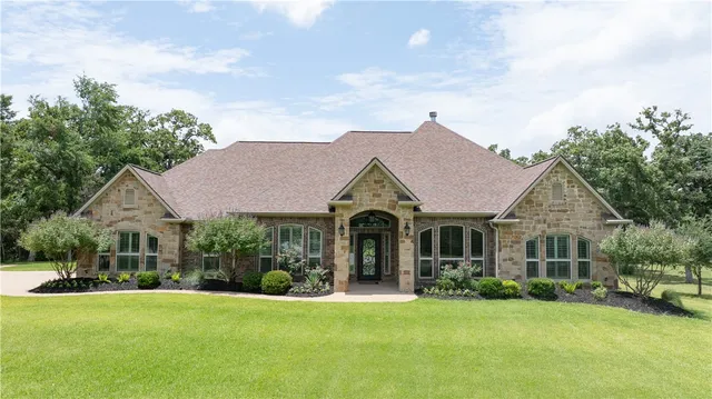 a front view of a house with a garden and porch
