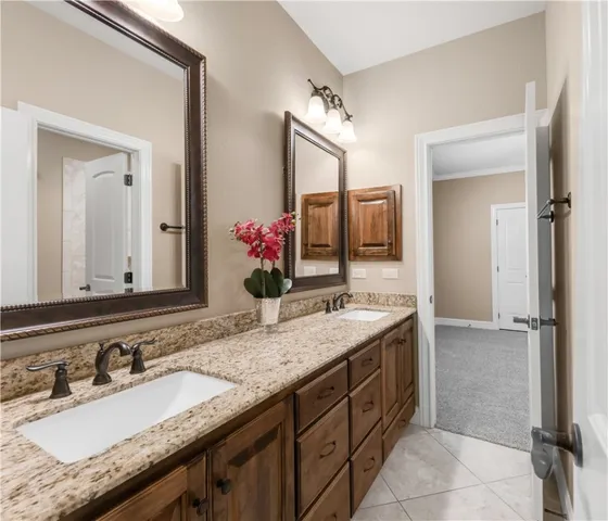 a bathroom with a granite countertop sink double and mirror