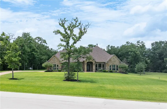 a front view of house with yard and green space