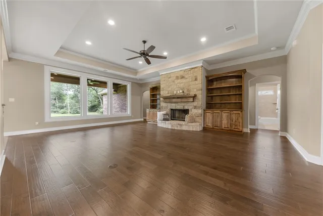 a view of empty room with wooden floor and windows
