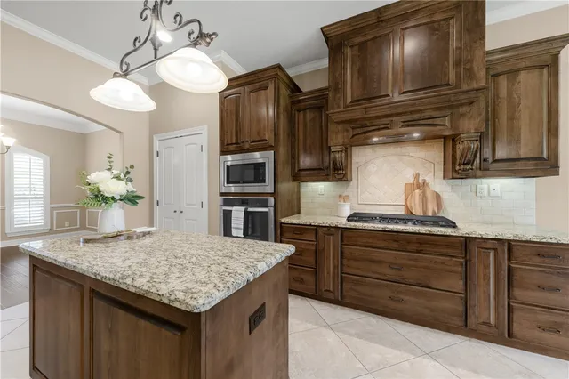 a kitchen with granite countertop stainless steel appliances and wooden cabinets