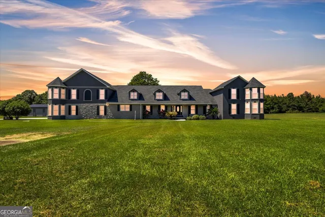 a front view of house with yard and green space