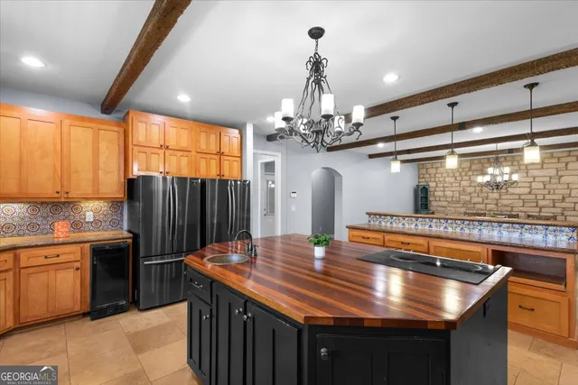 a view of a hallway with wooden floor and a bathroom