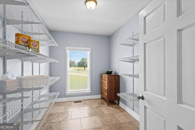 a view of an empty room with a fireplace and a large window