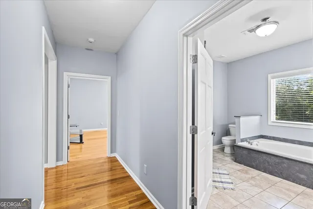 a view of a green field with trees in the background