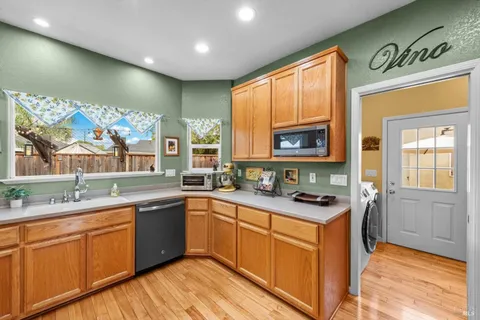 a kitchen with stainless steel appliances a sink stove and cabinets