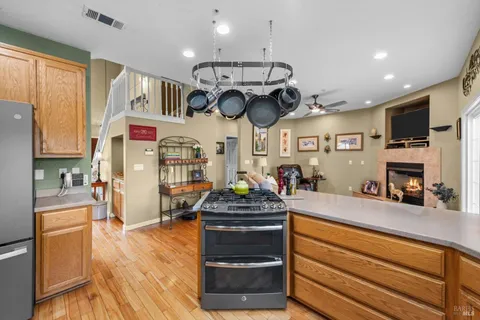 a kitchen with a stove and a wooden floor