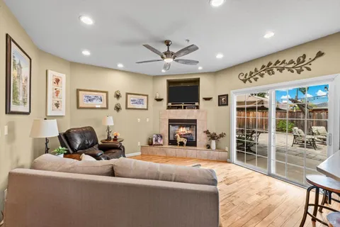 a living room with furniture a fireplace and a flat screen tv