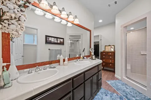 a en suite bathroom with a sink double vanity and a mirror