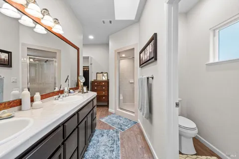 a bathroom with a tub sink and mirror