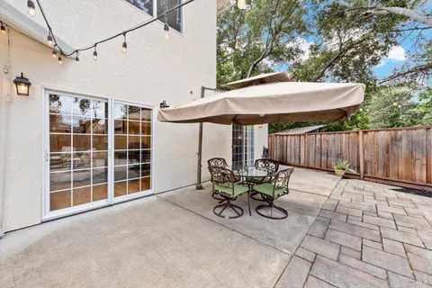 a view of a house with backyard and sitting area