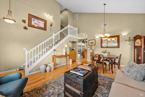 a living room with furniture and a chandelier