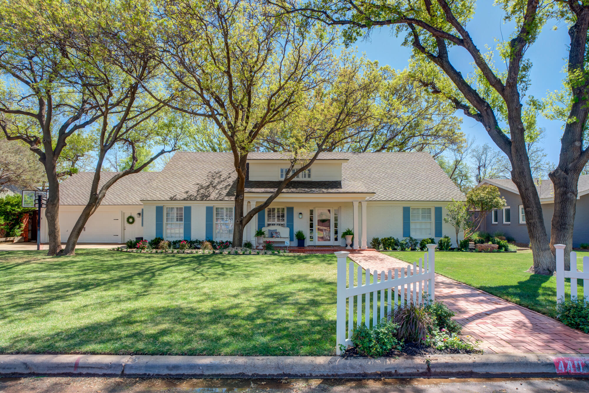 4407 13th Street Lubbock, TX 79416 - Photo 2 of 88 a front view of a house with garden