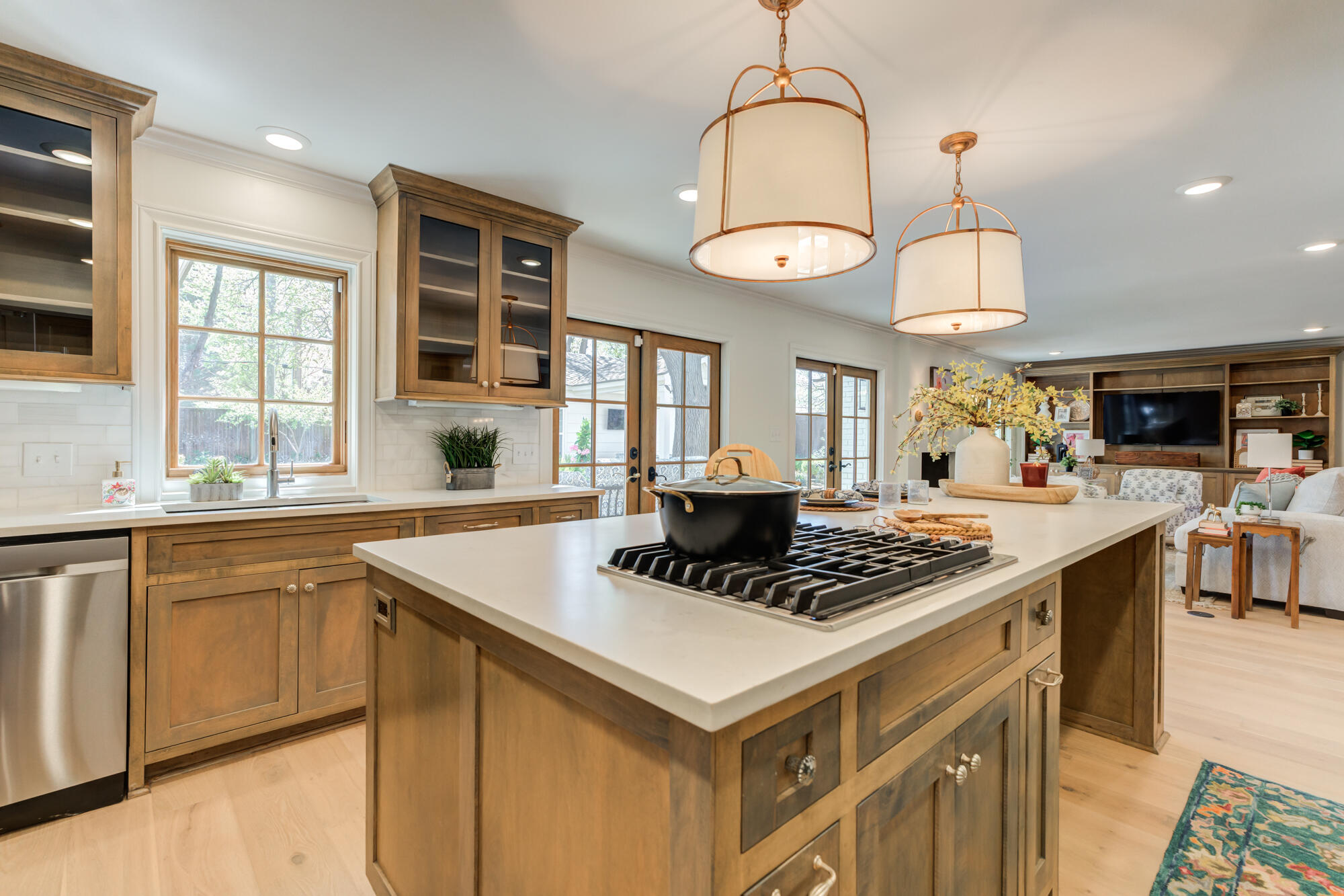 4407 13th Street Lubbock, TX 79416 - Photo 34 of 88 a kitchen with stainless steel appliances granite countertop a stove a sink dishwasher a dining table and chairs with wooden floor