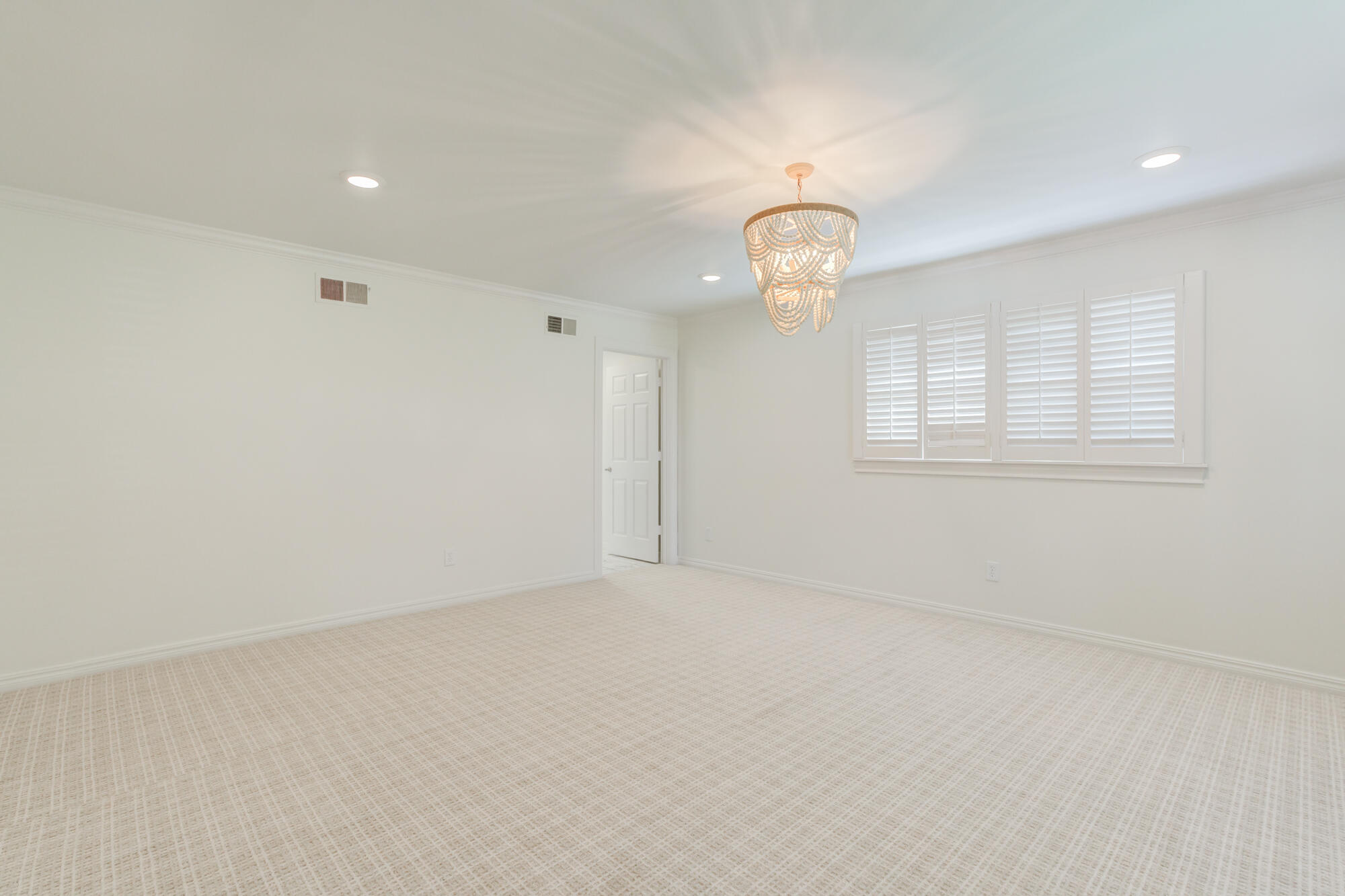 4407 13th Street Lubbock, TX 79416 - Photo 43 of 88 an empty room with a chandelier fan and windows