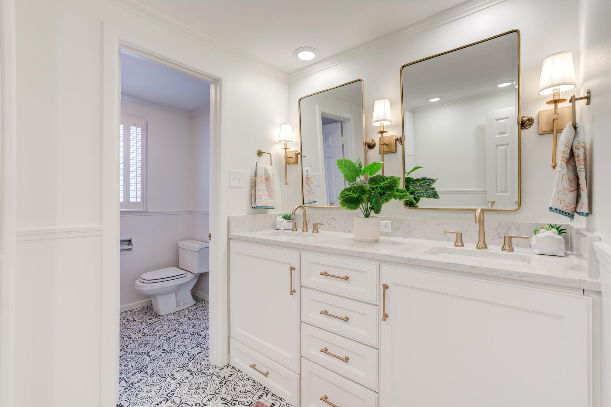 4407 13th Street Lubbock, TX 79416 - Photo 57 of 88 a bathroom with a granite countertop sink toilet and mirror