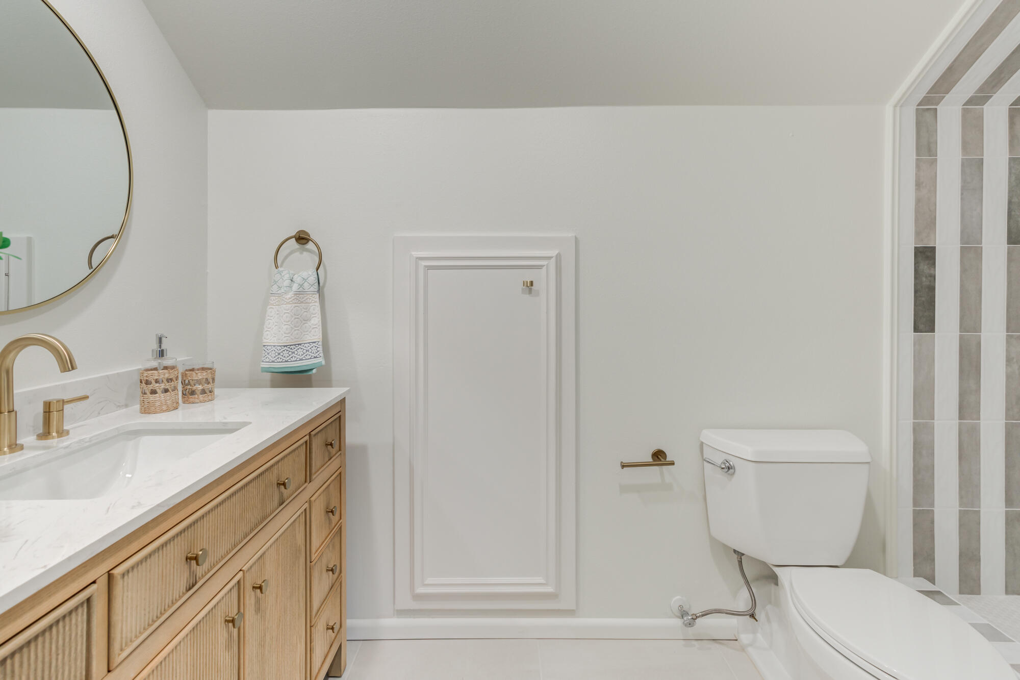 4407 13th Street Lubbock, TX 79416 - Photo 61 of 88 a bathroom with a toilet sink and mirror