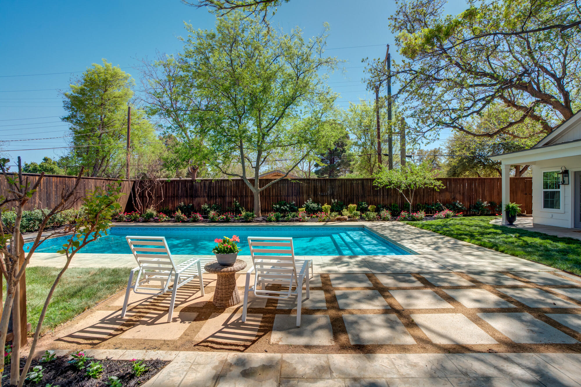 4407 13th Street Lubbock, TX 79416 - Photo 69 of 88 a view of backyard with swimming pool and outdoor seating