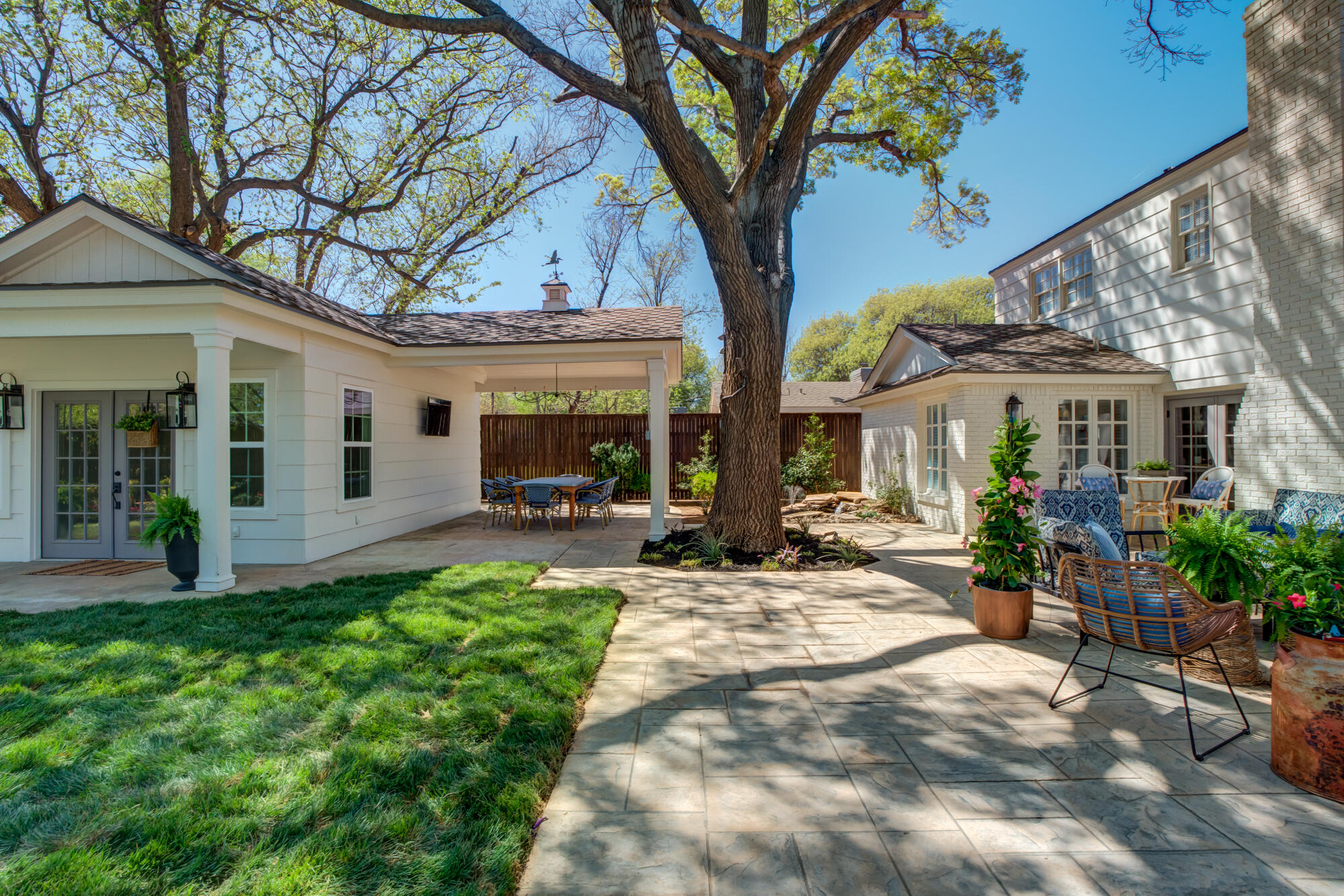 4407 13th Street Lubbock, TX 79416 - Photo 70 of 88 a view of a house with backyard sitting area and porch