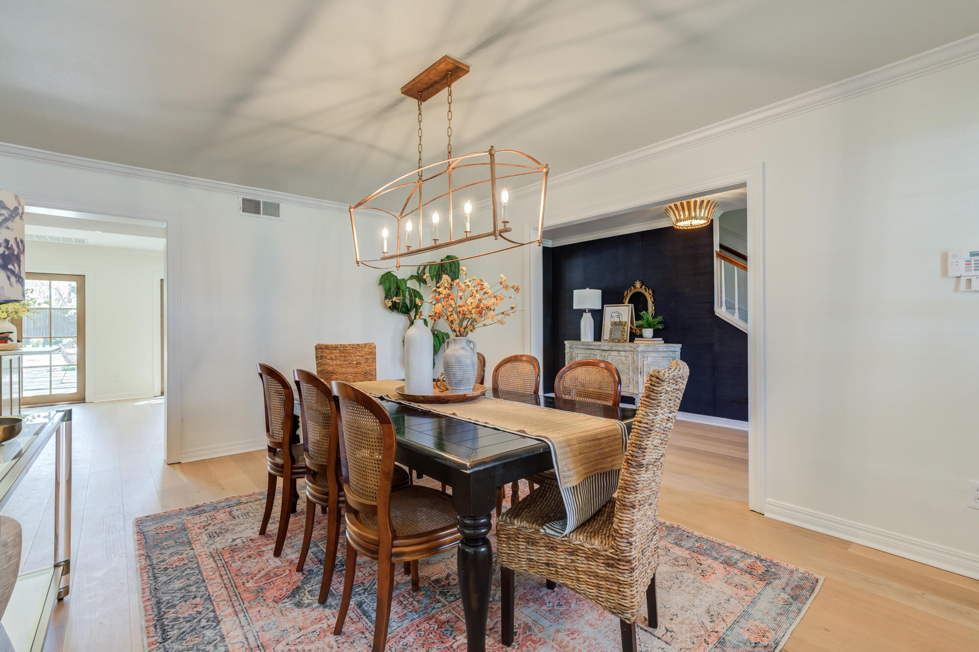4407 13th Street Lubbock, TX 79416 - Photo 9 of 88 a view of a dining room and livingroom with furniture wooden floor a chandelier