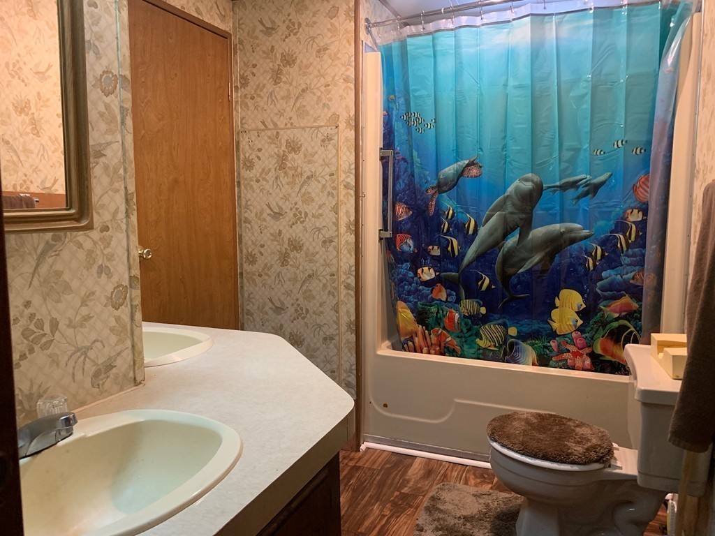 83 Clark Road, Unit 65 Shirley, MA 01464 - Photo 11 of 15 a bathroom with a sink toilet and shower