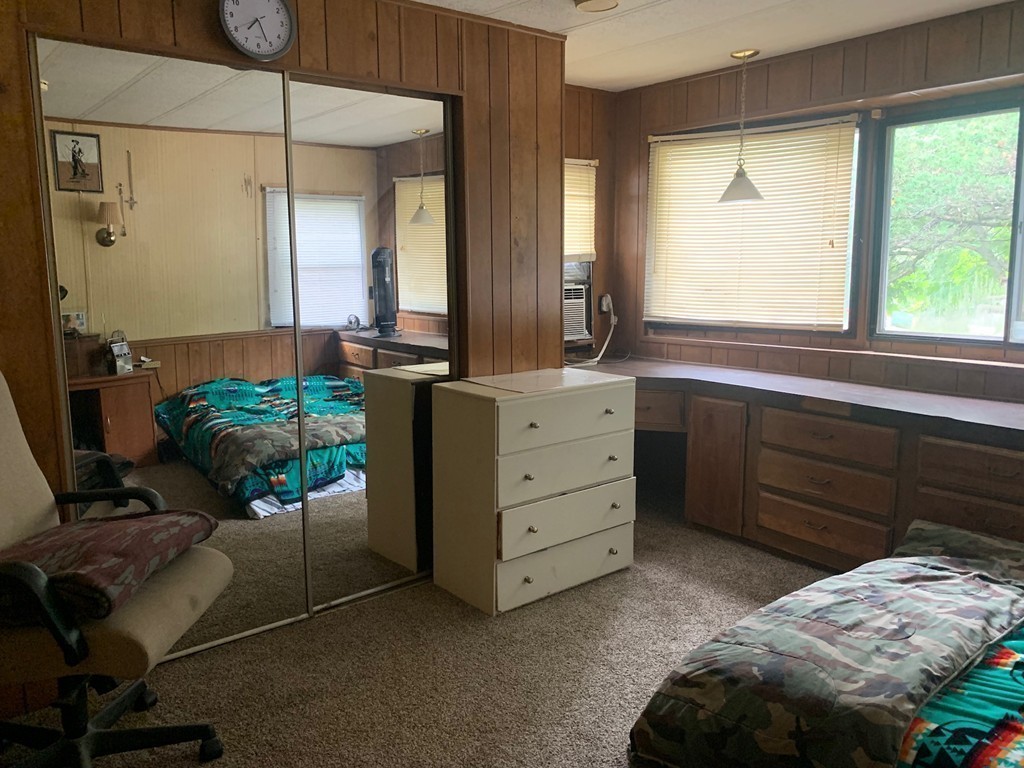 83 Clark Road, Unit 65 Shirley, MA 01464 - Photo 13 of 15 a bedroom with a bed and large windows