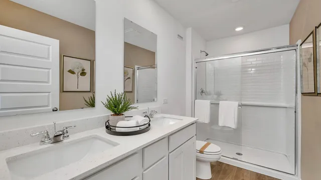 a bathroom with a sink a toilet and shower