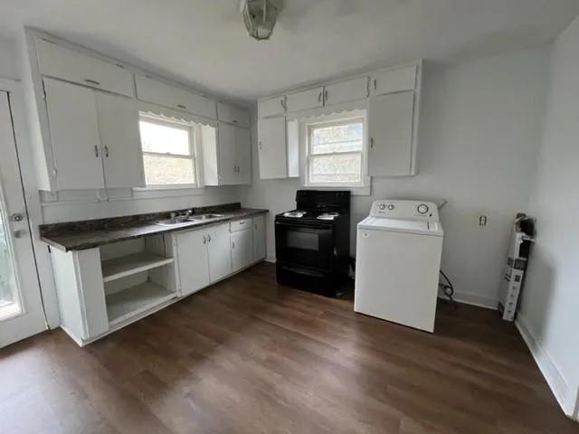 a kitchen with a stove a sink and a microwave