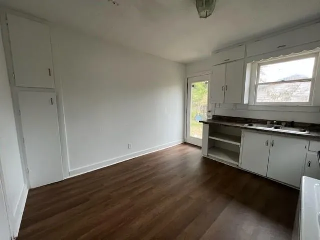 a kitchen with granite countertop a stove and cabinets