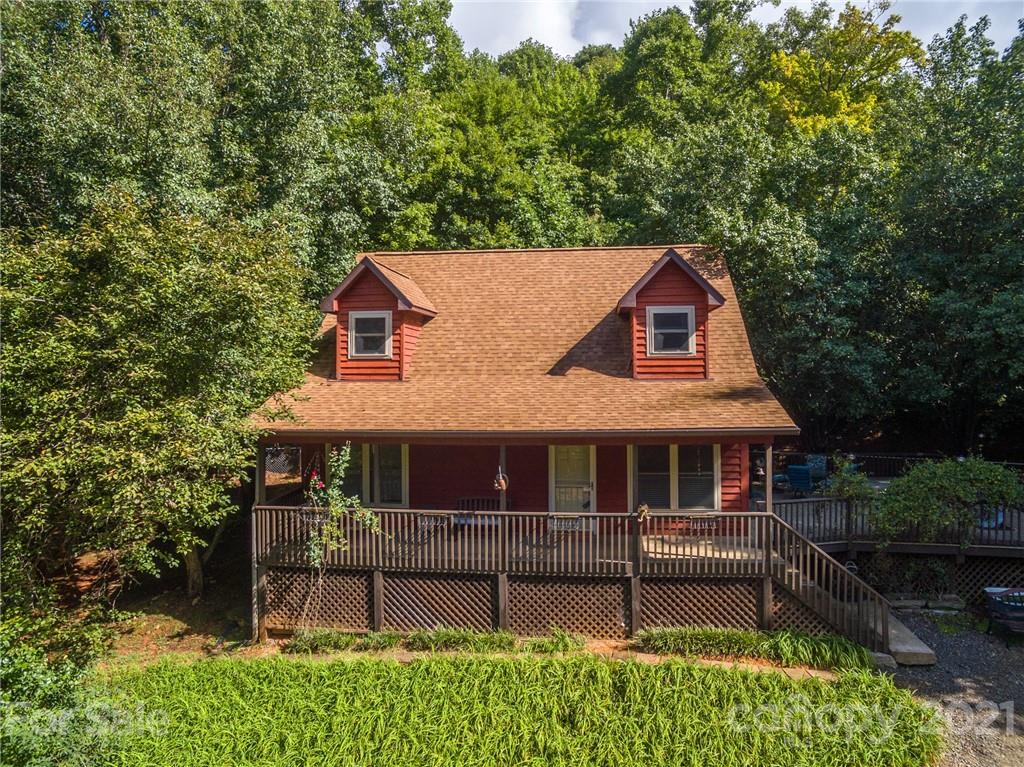 aerial view of a house with a small yard and wooden fence