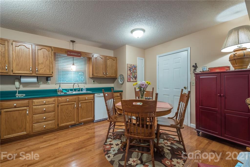 31 Bear Trail Fairview, NC 28730 - Photo 12 of 48 a kitchen with granite countertop wooden cabinets and dining table