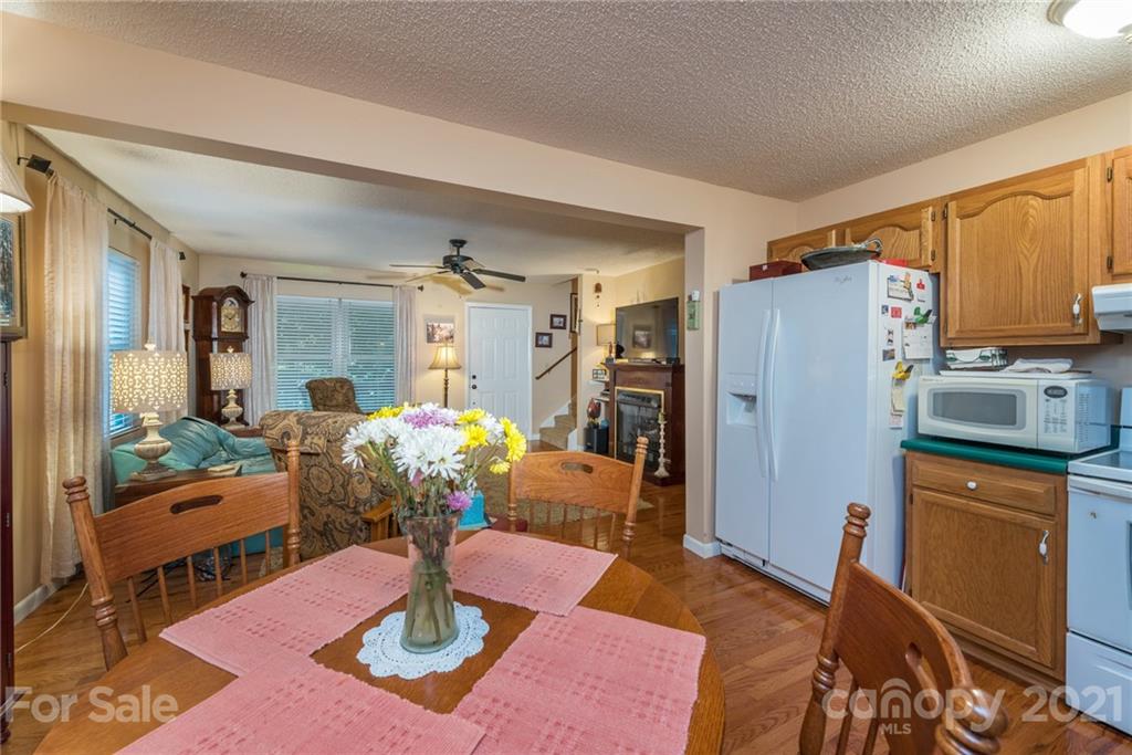 31 Bear Trail Fairview, NC 28730 - Photo 13 of 48 a kitchen with granite countertop a refrigerator and a stove