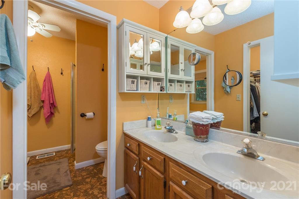 31 Bear Trail Fairview, NC 28730 - Photo 21 of 48 a bathroom with a double vanity sink mirror and toilet