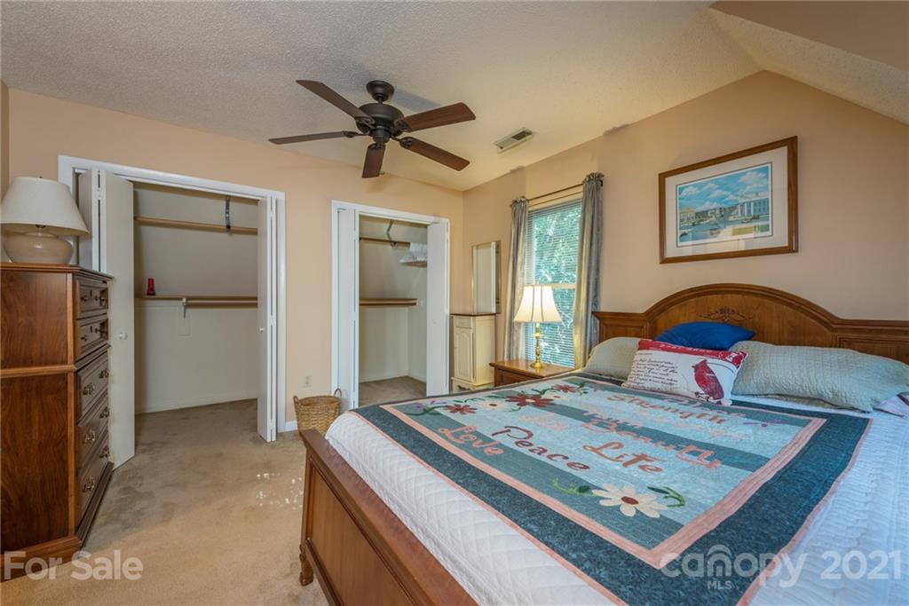 31 Bear Trail Fairview, NC 28730 - Photo 24 of 48 a bedroom with a bed and a chandelier