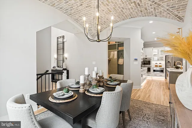 a dining room with furniture and a chandelier