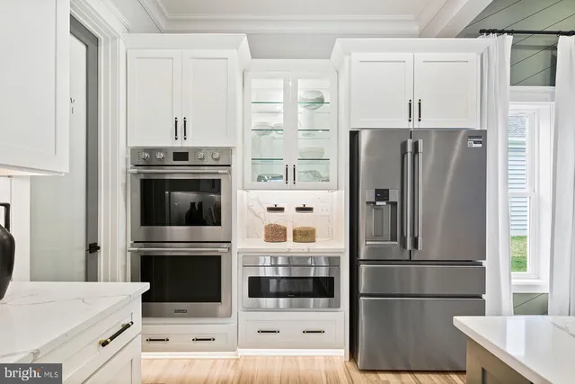 a kitchen with stainless steel appliances a stove microwave and cabinets