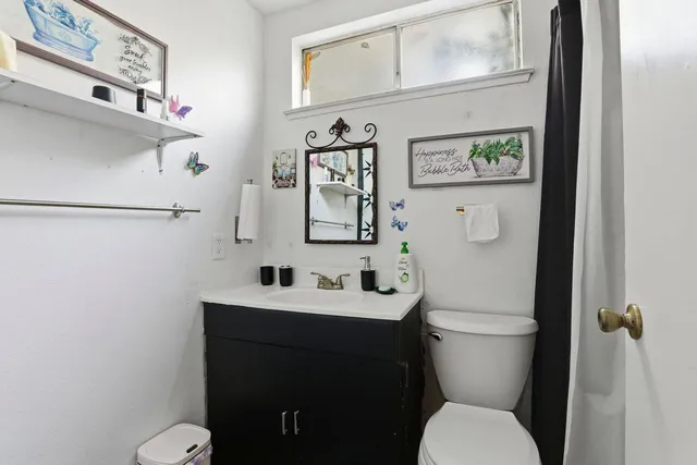 a bathroom with a toilet sink and mirror