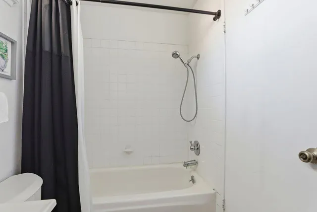 a bathroom with a shower and a bath tub