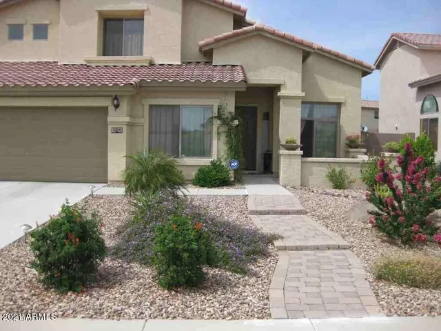 a front view of a house with garden