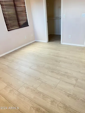 a view of an empty room with a kitchen
