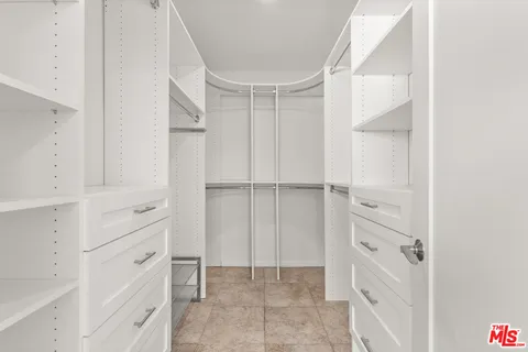 a bathroom with a white toilet sitting next to a bathroom sink