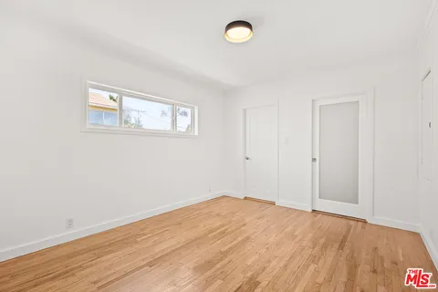 a bathroom with a toilet sink vanity and mirror